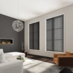 graphite coloured vertical window blinds covering multiple large windows in a modern living room