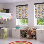 roller window blinds with a playful cartoon zoo animals print in a brightly lit childrens bedroom