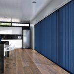 navy blue vertical window blinds covering a huge floor to ceiling window that spans a single wall in a modern kitchen